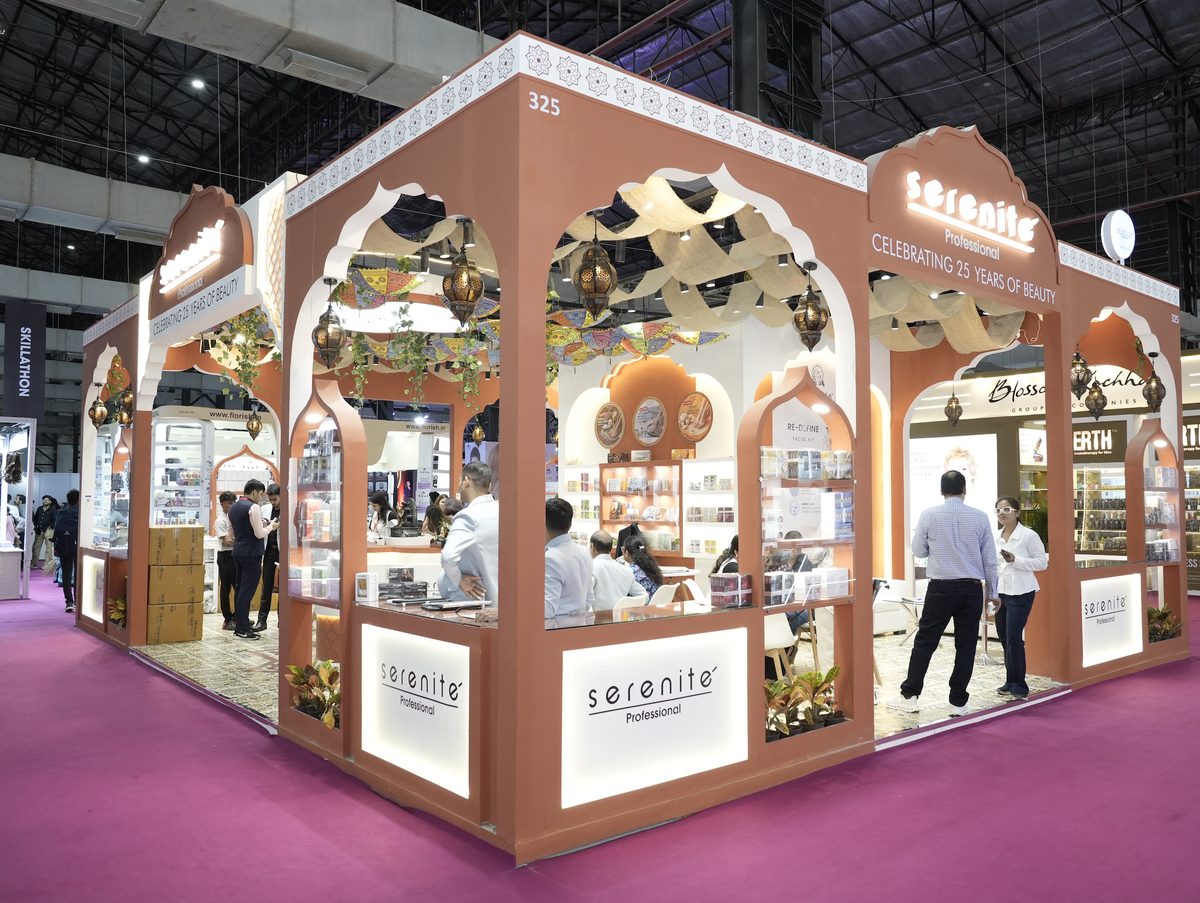Serenite Professional booth, Booth No. 325, at Professional Beauty India Mumbai 2026 — orange arched stand with lanterns and product displays