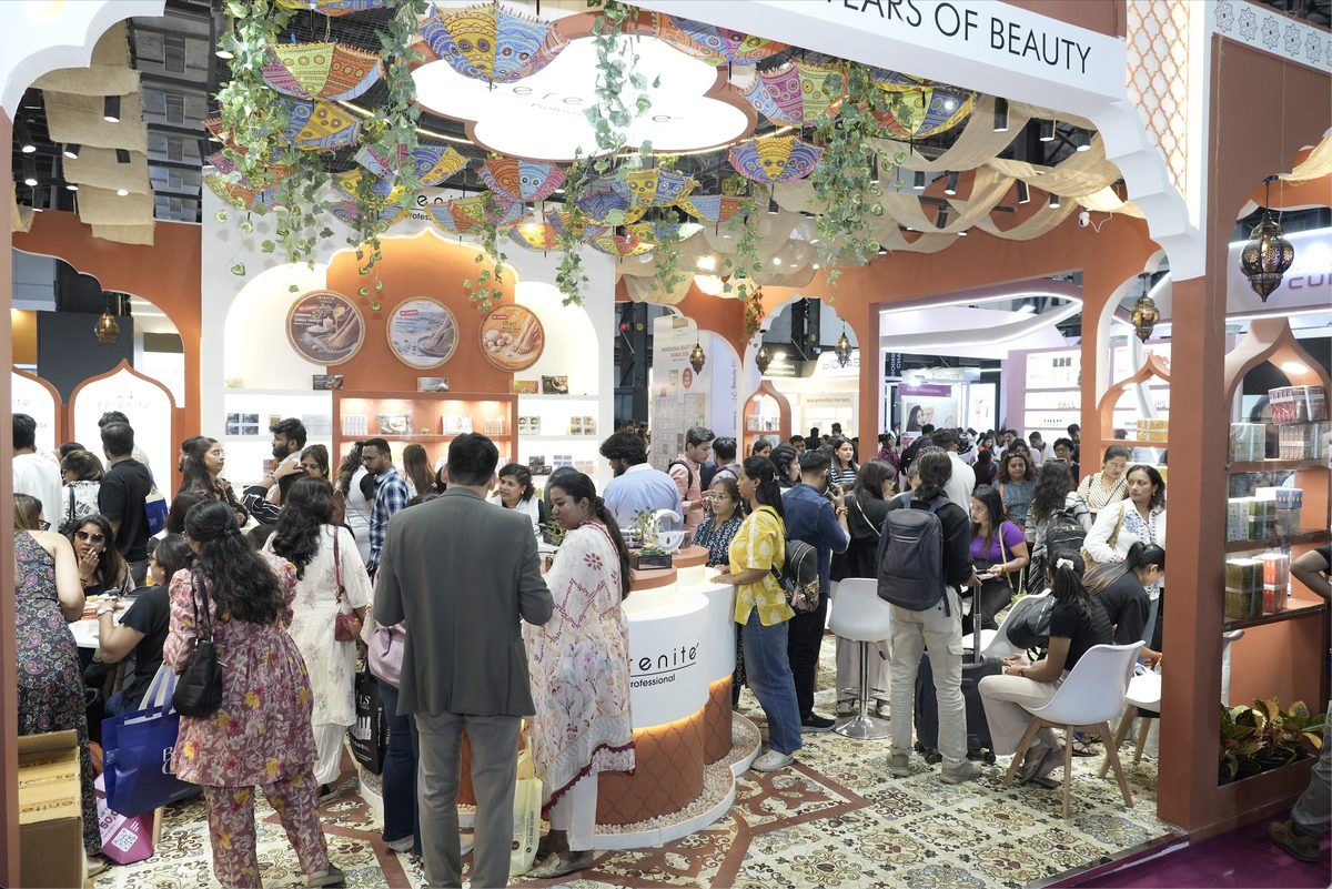 Inside the Serenite Professional booth: visitors at the consultation counter under the decorated ceiling, Professional Beauty India Mumbai 2026